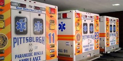 Three EMS Units park at emergency room.