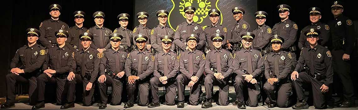 Photo of all police graduates on stage.