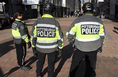 Three Bicycle Unit Police Officers standing together.