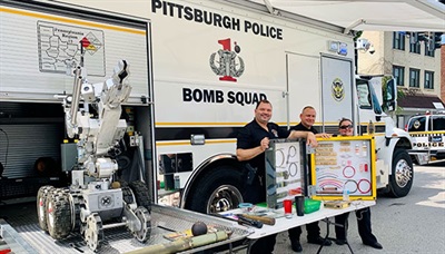 Bomb Squad team presenting their equipment and info at a public safety event.