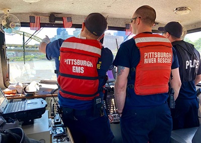 River Rescue officers on boat.