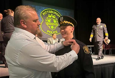 Police cadet receiving police badge.